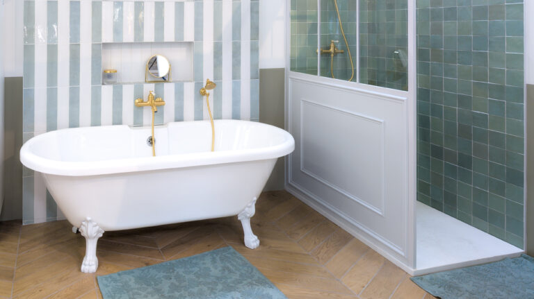 Salle de bains avec zellige rayé bleu ciel et blanc, baignoire à pattes de lion et douche habillée de zellige vert